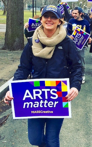 Student with Arts Matter sign