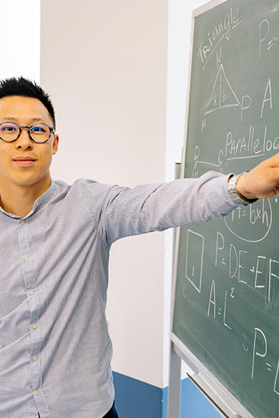 Math Educator pointing to a chalkboard