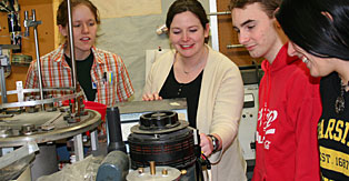 Students and professor performing an experiment