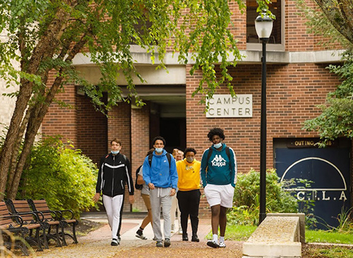 Group of students walking across campus