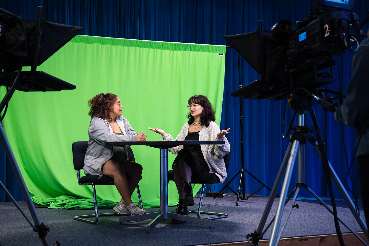 A student filming an interview for her research project.